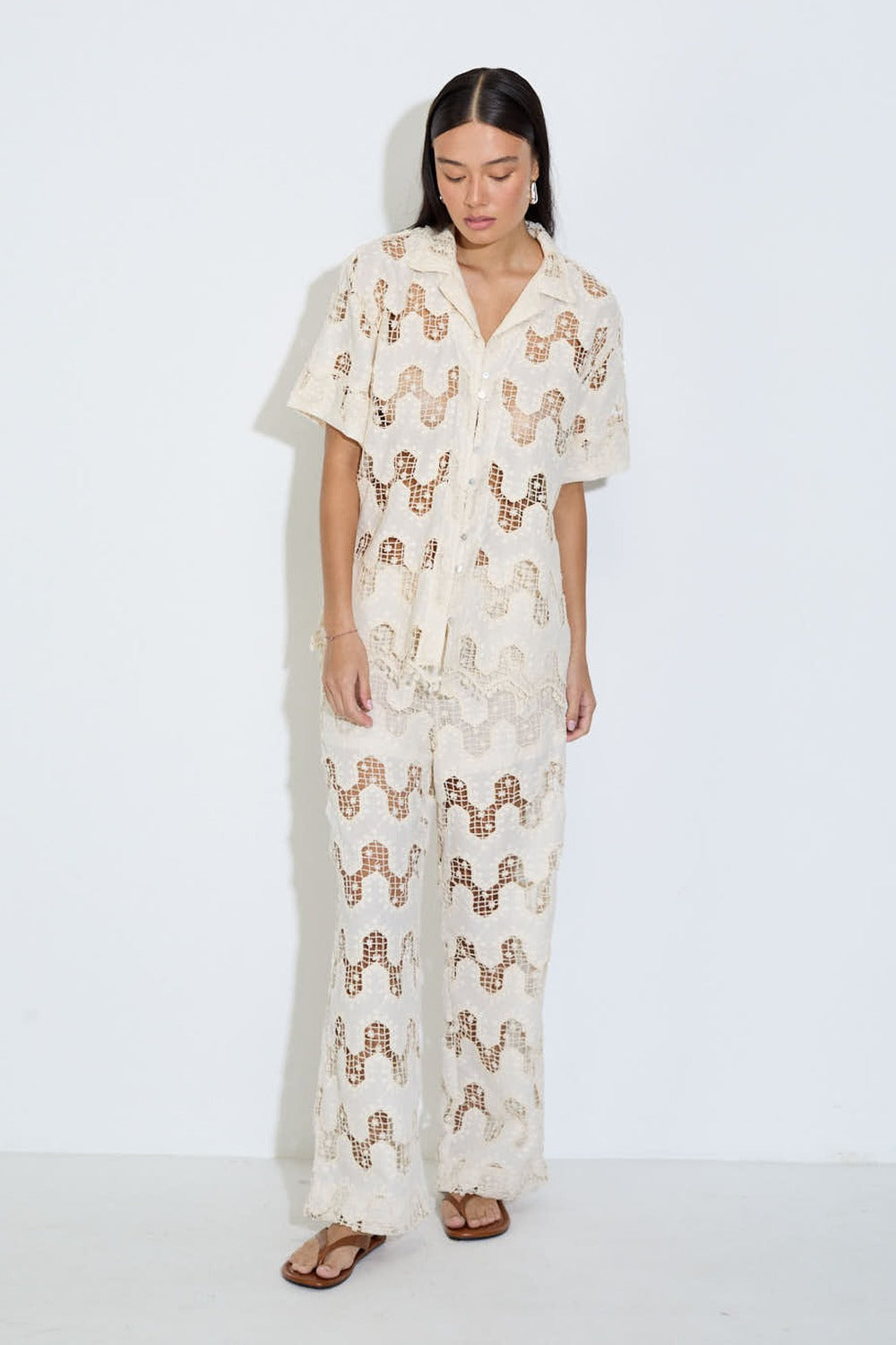 Model wearing the Cora ivory lace wide-leg pants with elasticated drawstring waist