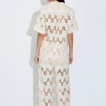 Model wearing the Cora ivory lace wide-leg pants with elasticated drawstring waist
