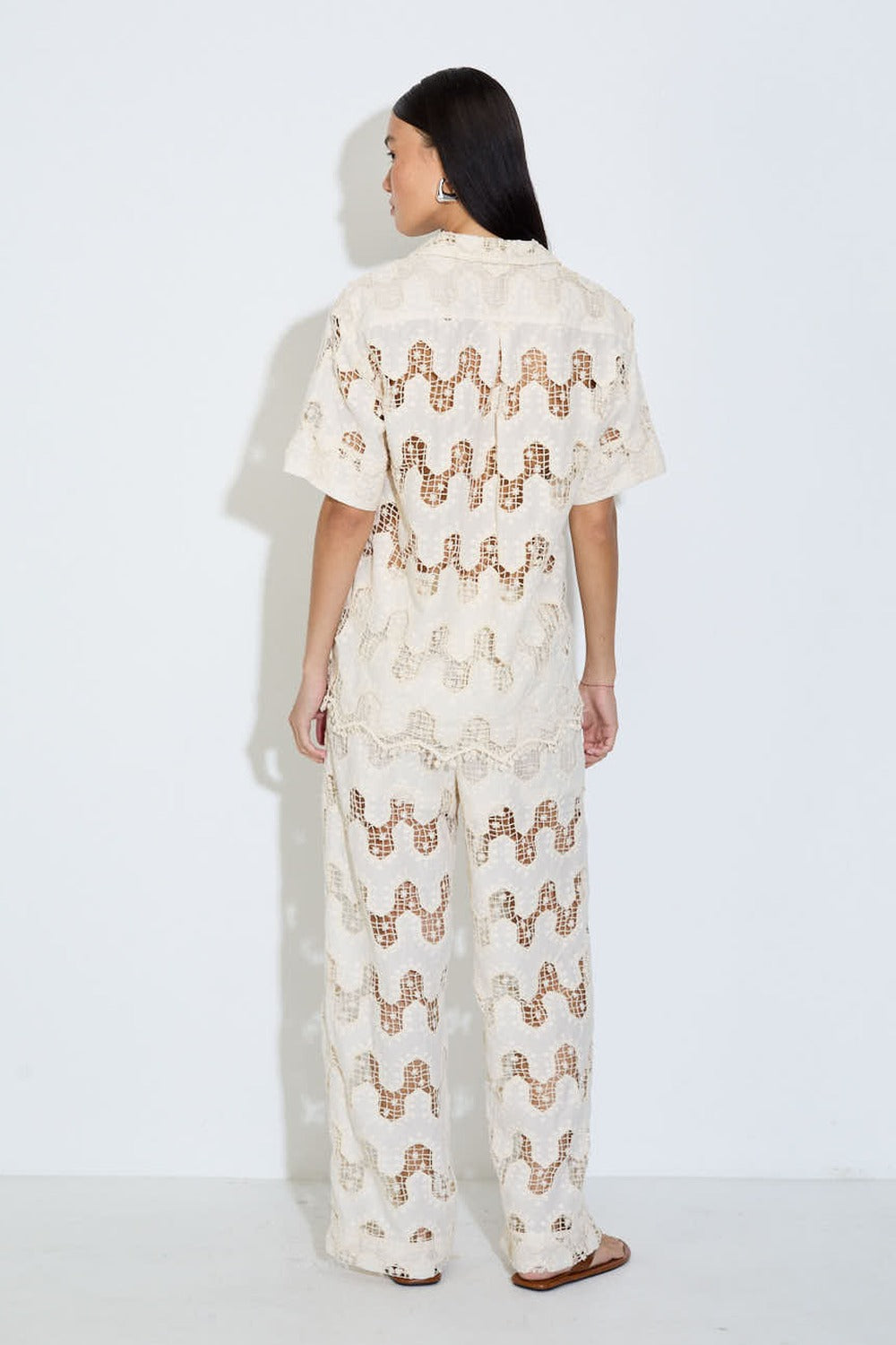 Model wearing the Cora ivory lace wide-leg pants with elasticated drawstring waist