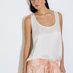 Model wearing the Daniella maxi skirt in peach floral viscose satin with elasticated waist