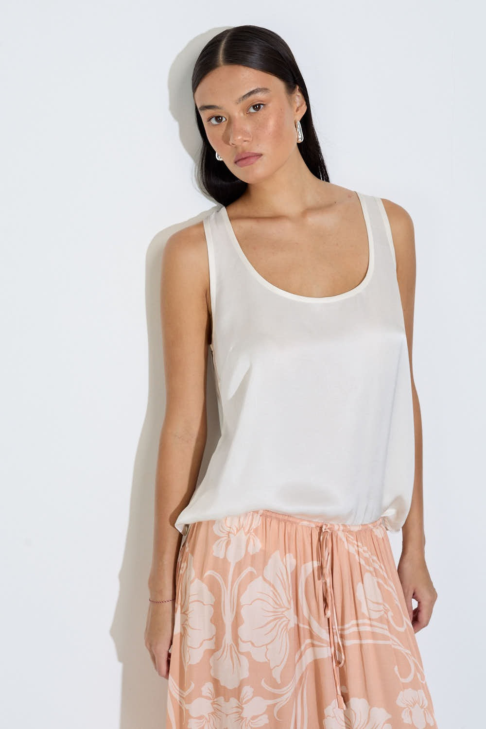 Model wearing the Daniella maxi skirt in peach floral viscose satin with elasticated waist