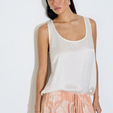Model wearing the Daniella maxi skirt in peach floral viscose satin with elasticated waist