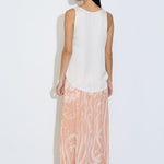 Model wearing the Daniella maxi skirt in peach floral viscose satin with elasticated waist