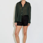 Model wearing the Nayara shirt in forest green cotton voile