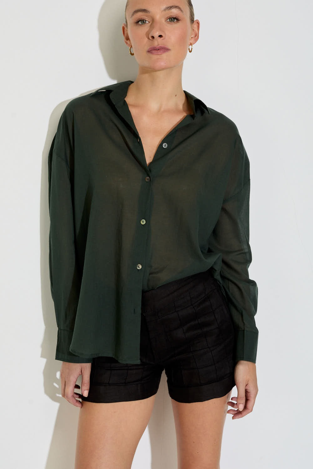 Model wearing the Nayara shirt in forest green cotton voile