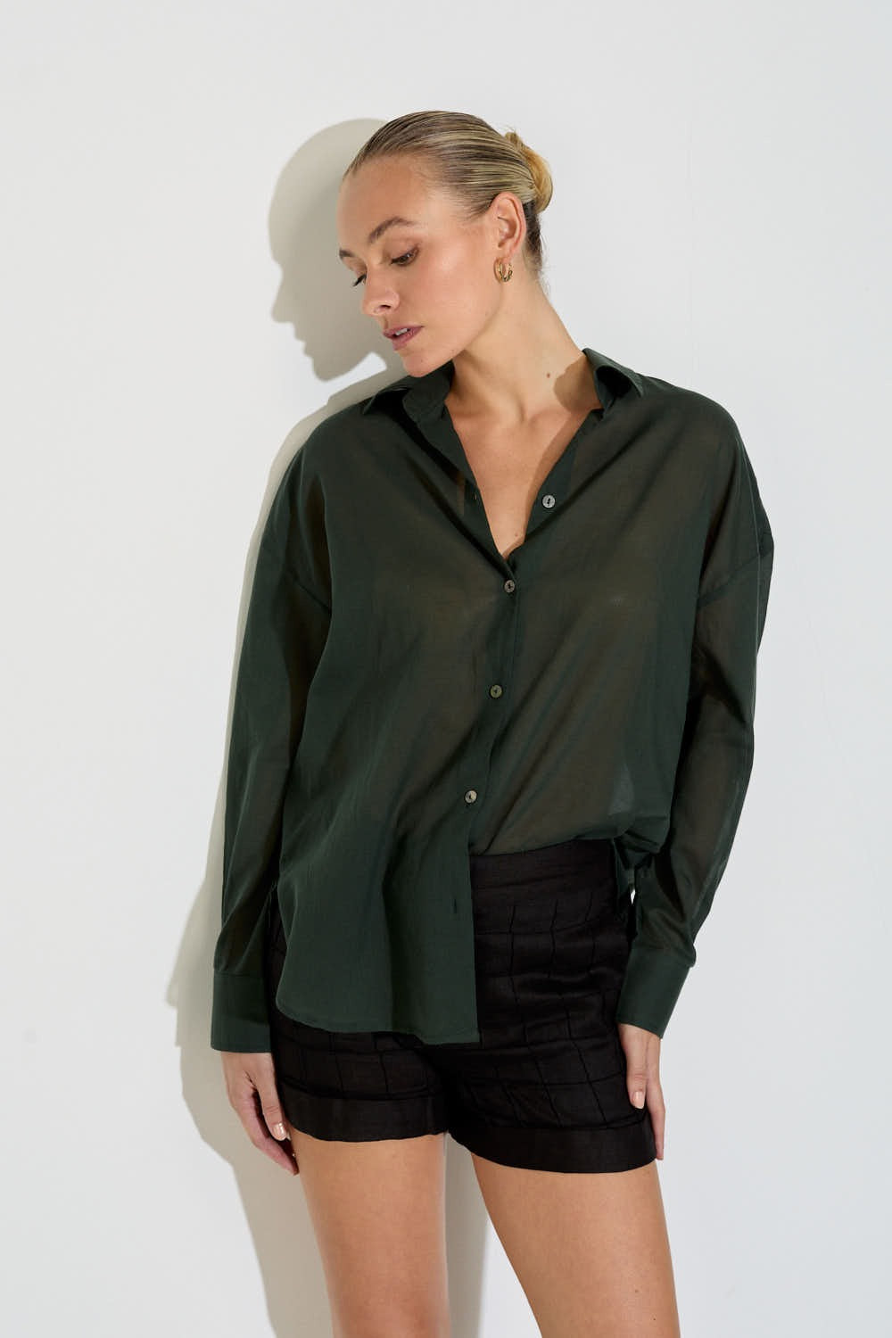 Model wearing the Nayara shirt in forest green cotton voile