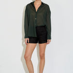 Model wearing the Nayara shirt in forest green cotton voile