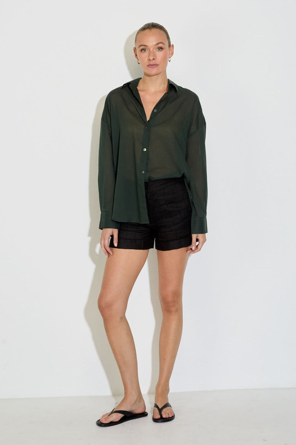 Model wearing the Nayara shirt in forest green cotton voile