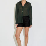 Model wearing the Nayara shirt in forest green cotton voile