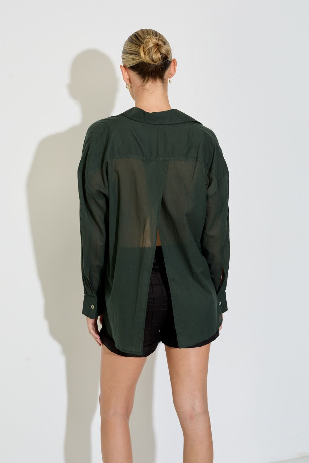 Model wearing the Nayara shirt in forest green cotton voile