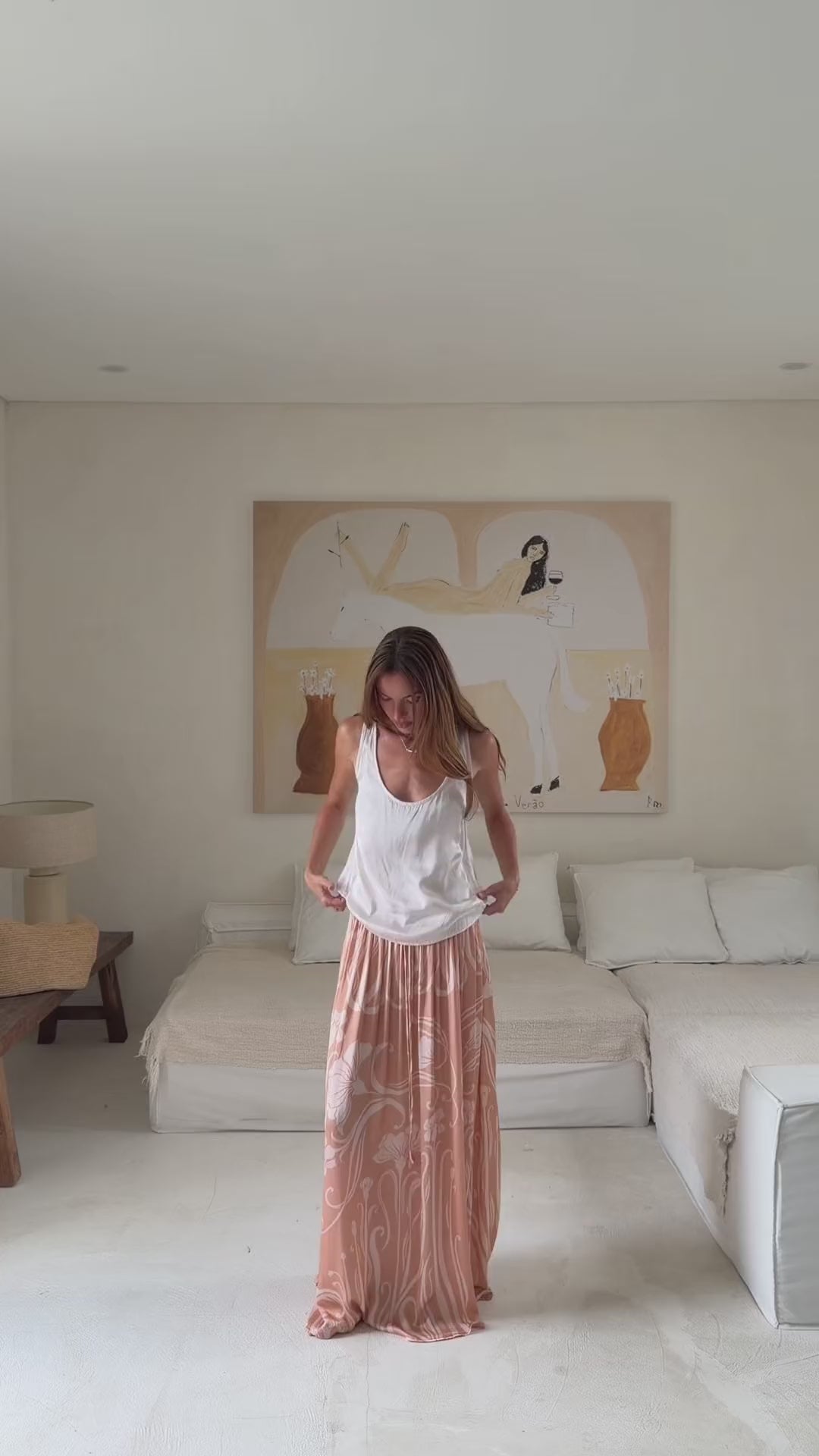Model styling the peach floral Daniella Maxi Skirt with a white shirt